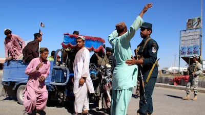 Afghan security officials check people and vehicles on a road side as security has been intensified ahead of parliamentary elections in Helmand, Afghanistan. EPA