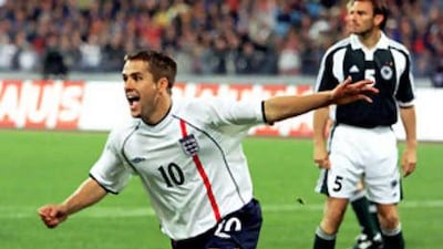 The England forward Michael Owen wheels away in celebration after scoring the second of his three goals in his side's 5-1 win over Germany in a World Cup qualifying match in Munich.