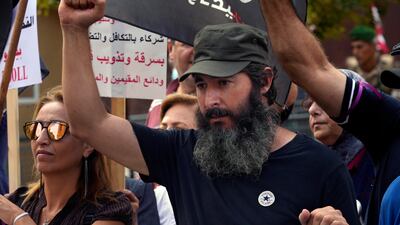 Bassam Al Sheikh Hussein joins a protest near Lebanon's parliament in Beirut against a capital controls draft law that protesters say will unfairly penalise depositors and protect Lebanon’s ruling class. AP