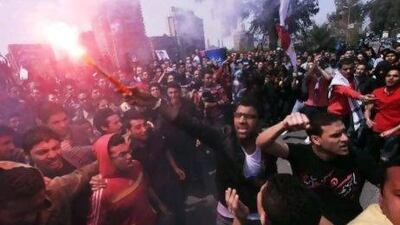 Egyptians, including one man holding a lit flare, chant slogans during a demonstration over the suspension of the Port Said football club following a deadly riot last month.