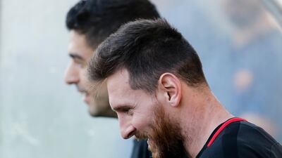 Lionel Messi and Luis Suarez smiles arrive for the training session. Pau Barrena / AFP