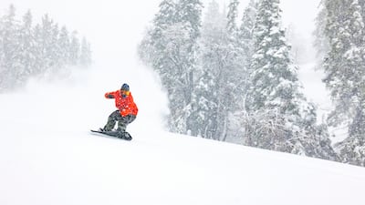 A snowboarder descends a mountain after one of the most significant storms of the season in Big Bear Lake. AP