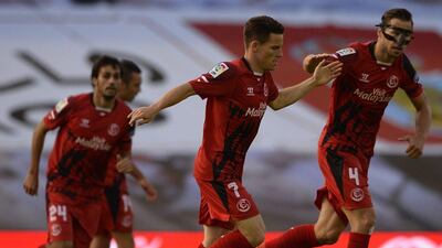 Sevilla's Kevin Gameiro, centre, celebrates with teammate Grzegorz Krychowiak on Sunday during their La Liga victory. Miguel Riopa / AFP / May 10, 2015