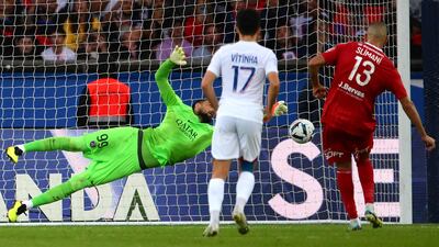 Gianluigi Donnarumma dives to save a penalty. AFP
