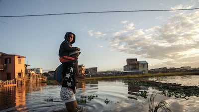 Residents walk in a flooded area of the 67-hectare Ankasina neighbourhood in Antananarivo, Madagascar, following a severe storm. AFP