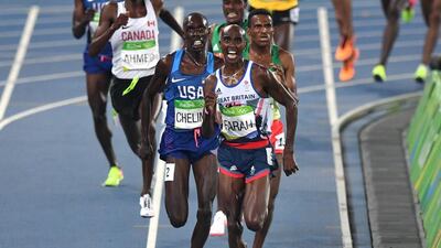 Britain's Mo Farah (front) and USA's Paul Chelimo compete in the Men's 5000m Final during the athletics event at the Rio 2016 Olympic Games at the Olympic Stadium in Rio de Janeiro on August 20, 2016. / AFP PHOTO / PEDRO UGARTE 28.7 x 20.42 cm res 300