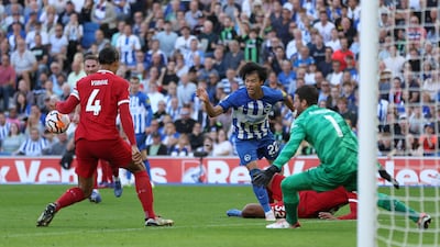 Brighton and Hove Albion's Kaoru Mitoma has a shot at goal that hits Liverpool's Virgil van Dijk on the arm. PA