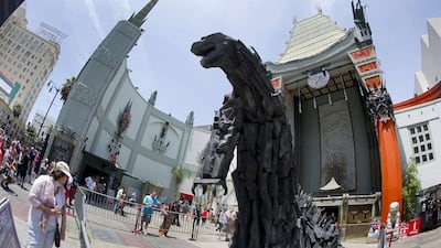 A 20-foot statue of Godzilla towers over the forecourt of the TCL Chinese Theatre in Hollywood, California on May 9, 2014 after it was unveiled. The latest version of the giant amphibian will hit the 3D screen at the TCL Chinese Theatre and across the United States on May 16. Robyn Beck / AFP