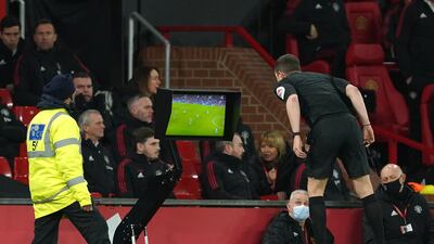 Rereree Peter Bankes checks the pitchside monitor before sending off Brighton's Lewis Dunk. PA