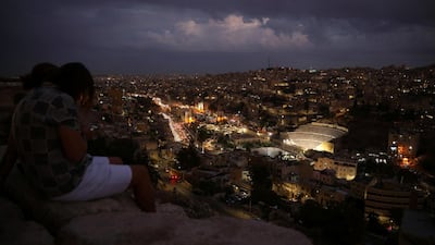 The Roman Amphitheatre area in downtown is seen as tourists sit during their visit to the Amman Citadel, an ancient Roman landmark, in Amman, Jordan. Reuters