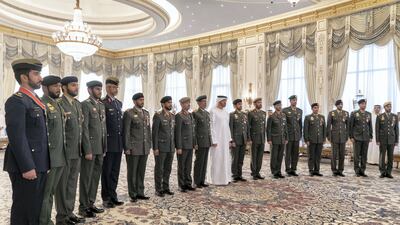 Seventeen servicemen stand with Sheikh Mohamed at the event
