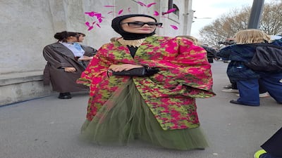 A net skirt combines with 1970s kimono and a feathered headdress