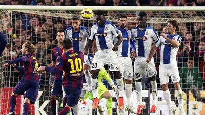 Lionel Messi plays a free kick during Barcelona's La Liga match against Espanyol on Sunday night at the Camp Nou. Alberto Estevez / EPA