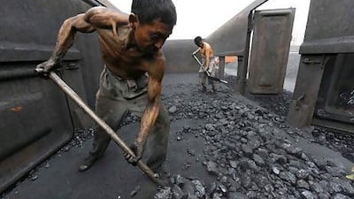 Workers unload coal at a storage site in China's Anhui province. Jianan Yu / Reuters