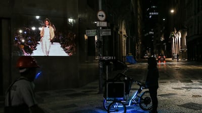 A bicycle with a projection system projects photos on a wall in celebration of 25 years of Sao Paulo Fashion Week in downtown Sao Paulo, Brazil. Getty Images