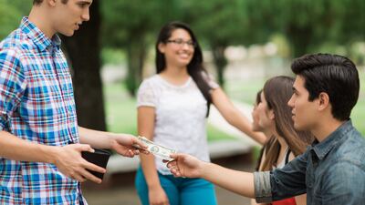 Ideally, before lending money, you should make a loan agreement outlining how much the borrower owes, how they’ll pay, when payment is due and what to do if they can’t pay. Getty Images