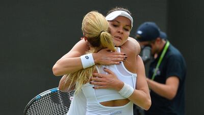 Poland's Agnieszka Radwanska, right, embraces Slovakia's Dominika Cibulkova after losing her women's singles fourth round match on Day 8 of the 2016 Wimbledon Championships at The All England Lawn Tennis Club in Wimbledon, southwest London, on July 4, 2016. AFP / GLYN KIRK