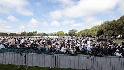 People listen the Adhan, the call for prayer, during a gathering for congregational Friday prayers and to observe two minutes of silence for victims of the twin mosque massacre, at Hagley Park in Christchurch on March 22, 2109. AFP