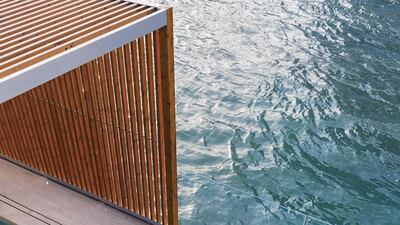 The pool is separated from the canal by a low-hanging glass wall