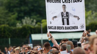 Supporters hold a banner welcoming Ronaldo to Juventus. AP Photo