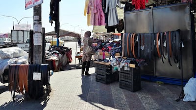 A lady browses the clothes of a shop in Zarqa, a city lcoated 30km north east of Amman, where a 16-year-old boy was abducted and tortured in a revenge attack.