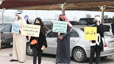 Business owners display placards during an anti-closures protest in Kuwait City. The Kuwaiti government stopped non-Kuwaitis entering the country for two weeks starting from February 7 to prevent the spread of the coronavirus. EPA
