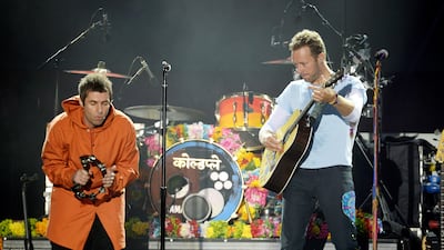 In this photograph released by One Love Manchester on June 4, 2017, UK musicians Liam Gallagher (L) and Chris Martin perform at the One Love Manchester benefit concert for the families of the victims of the Manchester terror attack. Dave Hogan for One Love Manchester / AFP Photo.