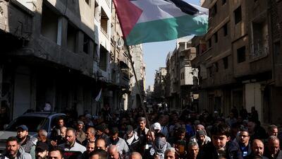 People attend a rally to show support for the ceasefire in Gaza, at the Yarmouk camp for Palestinian refugees, in Damascus. Reuters