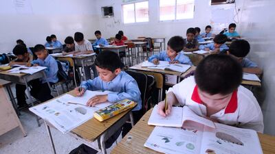 Dubai, September 11, 2011: Junior Grade three pupils writing at their Science class, at HH Shaikh Rashid Al Maktoum Pakistan School. (Jeffrey E Biteng / The National)
