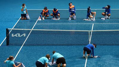 Ball kids dry the court after rain interrupted the Men's Singles Quarterfinals match between Stefanos Tsitsipas of Greece and Jannik Sinner of Italy during day 10 of the 2022 Australian Open at Melbourne Park in Australia. Getty Images