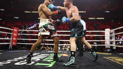 Saul Alvarez lands a right on Jaime Munguia at the T-Mobile Arena. AFP