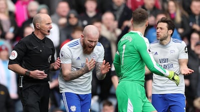 Cardiff City's Aron Gunnarsson remonstrates with referee Mike Dean after the match official overruled an earlier penalty decision against Burnley at Turf Moor. Reuters