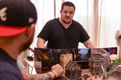 Sugie Reaves acts as the dungeon master and storyteller for a Dungeons & Dragons game, during a meetup in his apartment in Khalifa City, Abu Dhabi. Khushnum Bhandari / The National