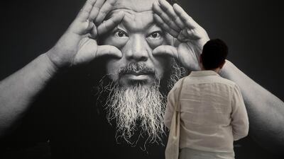 epa06068733 A visitor pauses at a photograph of Chinese artist Ai Weiwei at the exhibit, 'Ai Weiwei Trace at Hirshhorn', at the Hirshhorn Museum and Sculpture Garden in Washington, DC, USA, 05 July 2017. The exhibit featuring internationally famous Chinese artist Ai Weiwei is open to the public through the end of 2017. EPA/MICHAEL REYNOLDS