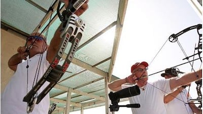 Rao Berenjian, left, and Ray Bellion practise at Sharjah Wanderers Golf Club.