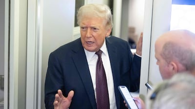 US President Donald Trump speaks with reporters aboard Air Force One. AFP