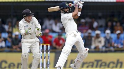 Virat Kohli and New Zealand’s wicketkeeper BJ Watling follow the ball after a shot. Rafiq Maqbool / AP Photo