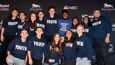 Shawn Mendes, fifth from left, and Khalid, forth from right, pose in the press room with the Stoneman Douglas choir, of the Marjory Stoneman Douglas High School at the Billboard Music Awards. AP