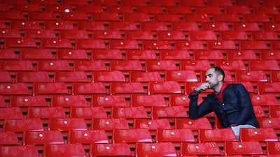 A Liverpool fan sits in the stands following their defeat in their English Premier League soccer match against Chelsea at Anfield in Liverpool, northern England April 27, 2014. REUTERS/Darren Staples