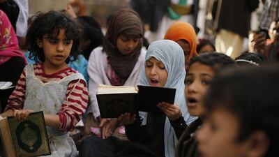 A girl recites the Quran during the Muslim fasting month of Ramadan, at the Grand Mosque in Sanaa, Yemen on June 29, 2014. Khaled Abdullah /Reuters