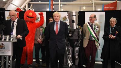 Britain's Prime Minister and Conservative leader Boris Johnson (C) reacts as the results are read out for the race to be MP for Uxbridge and Ruislip South at the count centre in Uxbridge, west London, on December 13, 2019 after votes were counted as part of the UK general election. AFP / Oli SCARFF