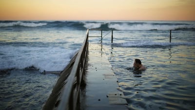 A swimmer splashes his face in between laps at a pool as the waves of the Pacific Ocean roll in during twilight at Sydney's South Cronulla Beach. Despite the sun setting earlier with a southern hemisphere winter approaching, Sydneysiders continue to take advantage of mild sea temperatures into May. Jason Reed / Reuters