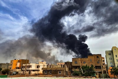 Smoke plumes billow from a fire at a lumber warehouse in southern Khartoum amidst ongoing fighting. AFP