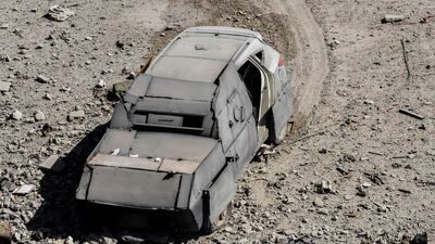 An unexploded car bomb is seen on the western frontline of Raqqa after its driver was shot by members of the Syrian Democratic Forces (SDF), on October 8, 2017. The SDF are battling to clear the last remaining ISIL fighters holed up in their crumbling stronghold of Raqqa. Bulent Kilic / AFP