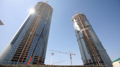 Sun Tower, right, and Sky Tower under construction on Reem Island in May, 2009. Sky Tower would become the tallest when it completed in 2010. Sammy Dallal / The National