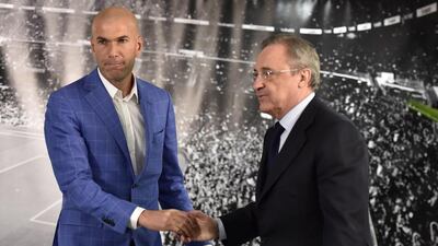 Real Madrid named Zinedine Zidane, left, as their new coach on Monday and is congratulated by Real Madrid's president Florentino Perez after a statement at the Santiago Bernabeu stadium in Madrid. Rafael Benitez's unhappy reign in charge of Real Madrid came to an end after just seven months and 25 games when he was sacked. AFP PHOTO/ GERARD JULIEN
