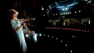 A guest holds a real Oscar statuette inside The Oscars Experience. Reuters