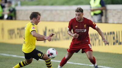 Alex Oxlade-Chamberlain looks to win the ball for Liverpool on the flank.