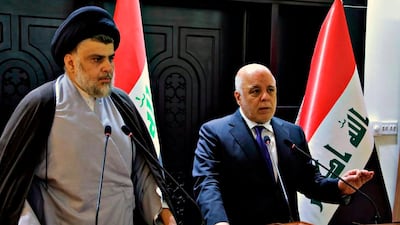 Iraqi Prime Minister Haider Al Abadi, right, and Shiite cleric Moqtada Al Sadr hold a press conference in Baghdad, Iraq, early Sunday, May 20, 2018. Iraqi Government via AP