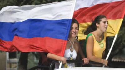 Girls hold russian and South Ossetian separatists' flags in Tskhinvali, South Ossetia, yesterday.